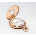 A gentleman's 9ct yellow gold half hunter pocket watch with enamelled numerals, contained in a