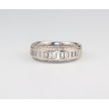 An 18ct white gold baguette and brilliant cut diamond ring size O, 4 grams