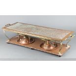 An Edwardian copper and brass twin handled, twin burner, rectangular hot plate, raised on bun feet