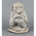 A 19th/20th Century cast lead figure of a seated monkey 27cm x 19cm x 18cm Some contact marks