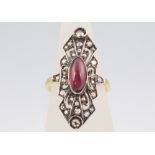 A yellow metal oval cabochon cut garnet and diamond dress ring, 3.9 grams, size K 1/2