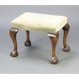 A Queen Anne style rectangular mahogany dressing stool, raised on cabriole, ball and claw supports