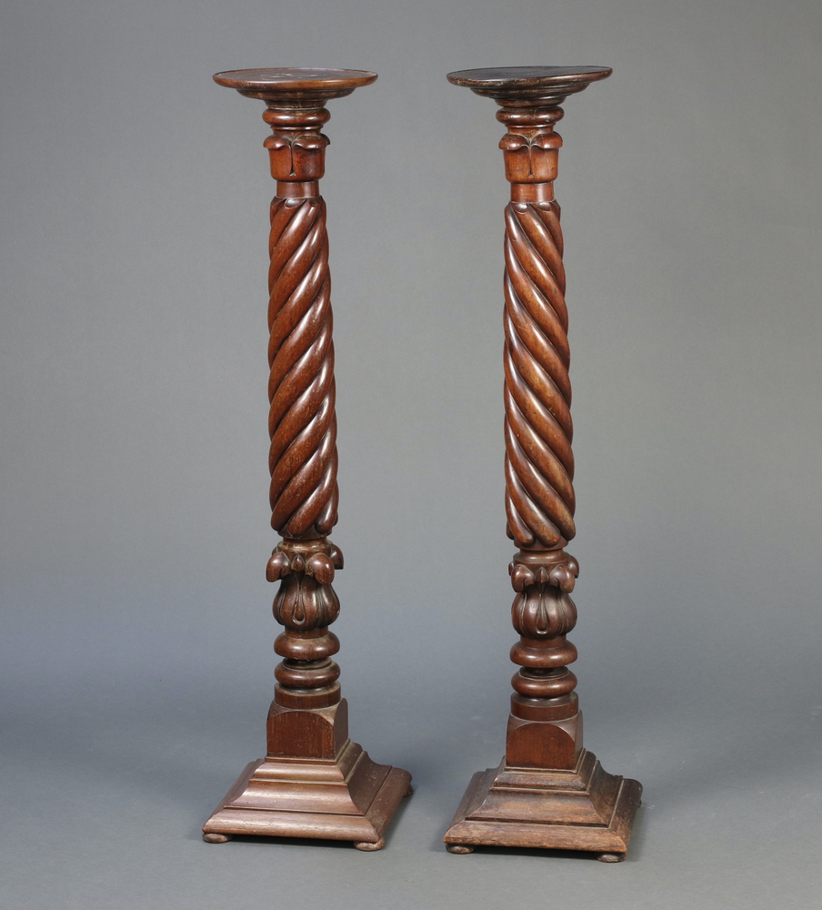 A near pair of William IV carved mahogany bed post torcheres, raised on square stepped bases 136cm h