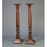 A near pair of William IV carved mahogany bed post torcheres, raised on square stepped bases 136cm h