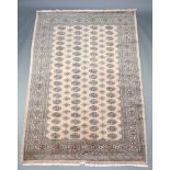 A sand and black ground Bokhara carpet with 76 octagons to the centre 275cm x 189cm