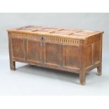 An 18th Century panelled oak coffer with hinged lid and iron butterfly hinges, the interior fitted a