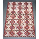 A white, turquoise and tan ground Kilim style machine made rug 215cm x 155cm