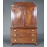 A 19th Century mahogany linen press, the upper section with moulded cornice, the interior fitted 3