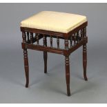 An Edwardian rectangular mahogany stool with bobbin turned decoration, raised on turned supports