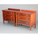 A pair of Edwardian inlaid mahogany chests with raised backs and 3 drawers, raised on square tapered