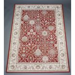 A tan and white ground Aubusson style machine made rug with floral design to the centre 213cm x