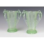 A pair of "Josef Feigl" Czechoslovakian Art Deco pale green glass moulded flared neck vases with