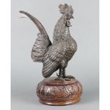 A bronze figure of a standing cockerell raised on an associated hardwood base 40cm h x 17cm