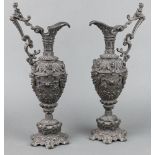 A pair of Victorian cast spelter ewers with mask decoration, raised on panelled feet 40cm h x 20cm w