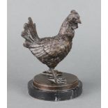 A bronze figure of a standing chicken, raised on a black veined marble base 19cm x 12cm