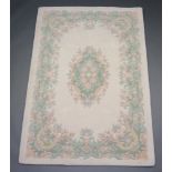 A white ground and floral patterned Indian rug 182cm x 124cm Some light staining in places