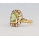 A yellow metal peridot and diamond ring, the centre stone 1.5ct, the diamonds 0.40ct, 3 grams,