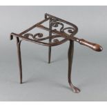 A 19th Century wrought steel, arch shaped range trivet with turned wooden handle 27cm x 40cm x 24cm