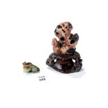 A CHINESE MOTTLED BROWN/GREEN JADE OF AN ANIMAL AND HER YOUNG (losses to front feet),