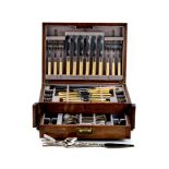 AN EARLY 20th CENTURY OAK CANTEEN CASE containing sundry EPNS CUTLERY,