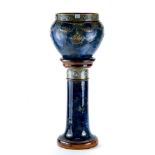 A ROYAL DOULTON STONEWARE JARDINIERE AND PEDESTAL blue/green glaze decorated with raised swags and