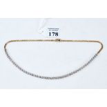 A 14K YELLOW/WHITE GOLD DIAMOND NECKLACE set with fifty diamonds, stamped 14K, approx 14.2 grams.