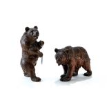 AN EARLY 20TH CENTURY BLACK FOREST CARVED WOODEN BEAR standing on all fours,