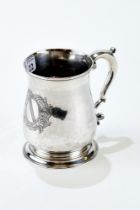 A GEORGE II SILVER BALUSTER SHAPED ONE-PINT TANKARD, engraved crest and scroll handle,