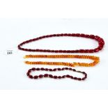 A 20th CENTURY AMBER NECKLACE, 19" long, a period graduated cherry red Amber NECKLACE, 16" long,