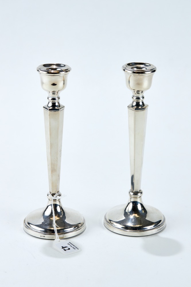 A PAIR OF ELIZABETH II SILVER TABLE CANDLESTICKS with tapering hexagonal stems on circular bases,