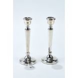 A PAIR OF ELIZABETH II SILVER TABLE CANDLESTICKS with tapering hexagonal stems on circular bases,