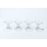A SET OF FOUR VICTORIAN CUT-GLASS PEDESTAL SALT CELLARS with flared rims,