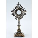 AN 18th/19th CENTURY FRENCH WHITE METAL MONSTRANCE of typical sunburst form raised on a rectangular
