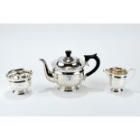 A GEORGE VI SILVER THREE-PIECE TEA SET, of circular form, ebonized handle, maker EV, Sheffield 1937,