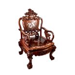 A PAIR OF CHINESE HARDWOOD ARMCHAIRS profusely carved with dragons and shi-shi dogs,