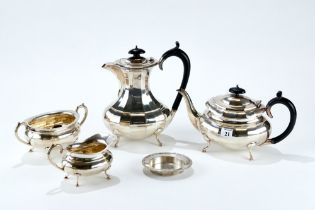 A GEORGE V SILVER THREE-PIECE TEA SET of oval panelled form, raised on four cabriole legs, maker: A.