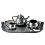 A LIBERTY & CO THREE PIECE TEA SET of conical form with stylized decoration,