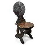 AN EARLY 20th CENTURY JAPANESE PINE HALL CHAIR with foliate carved back and seat raised on end