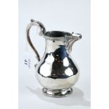A VICTORIAN SILVER PEAR-SHAPED CREAM JUG with beaded borders and scroll handle, maker: A.