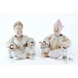 A PAIR OF LATE 19th CENTURY CONTINENTAL BISQUE PORCELAIN SEATED EASTERN FIGURES with nodding heads