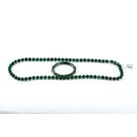 A CHINESE GREEN JADE BAMBOO EFFECT BANGLE and a similar polished green Jade NECKLACE, 32" long (2).