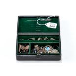 A 19th CENTURY BLACK LEATHER JEWELLERY BOX containing sundry white metal and other jewellery.