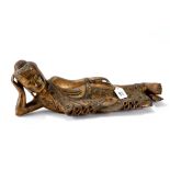 A BURMESE CARVED AND GILDED WOOD FIGURE OF A RECLINING BUDDHA with mirror glass jewelling,