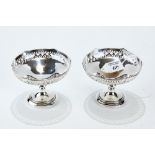 A PAIR OF GEORGE V SILVER PEDESTAL COMPORTS with shaped pierced rims, maker: W.D.