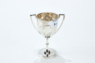 AN EDWARDIAN SILVER DOUBLE HANDLED TROPHY CUP with vacant cartouche and embossed foliate decoration,