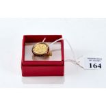A 1914 GOLD HALF SOVEREIGN in a 9ct gold ring mount, size P, approx 10 grams.