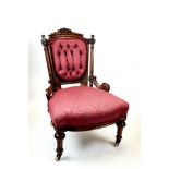 A PAIR OF LATE 19th CENTURY WALNUT NURSING CHAIRS, the foliate carved and upholstered backs,