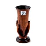 A 19th CENTURY CARVED WOODEN VASE supported by a hand, inscribed SOUVENIR FROM PITCAIRN,