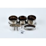 TWO GEORG JENSEN DANISH SILVER SERVIETTE RINGS, two hallmarked silver DITTOs, and a .