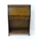 An early 20thC oak student's bureau. Approx. 42" high x 29" wide x 10" deep Please Note - we do